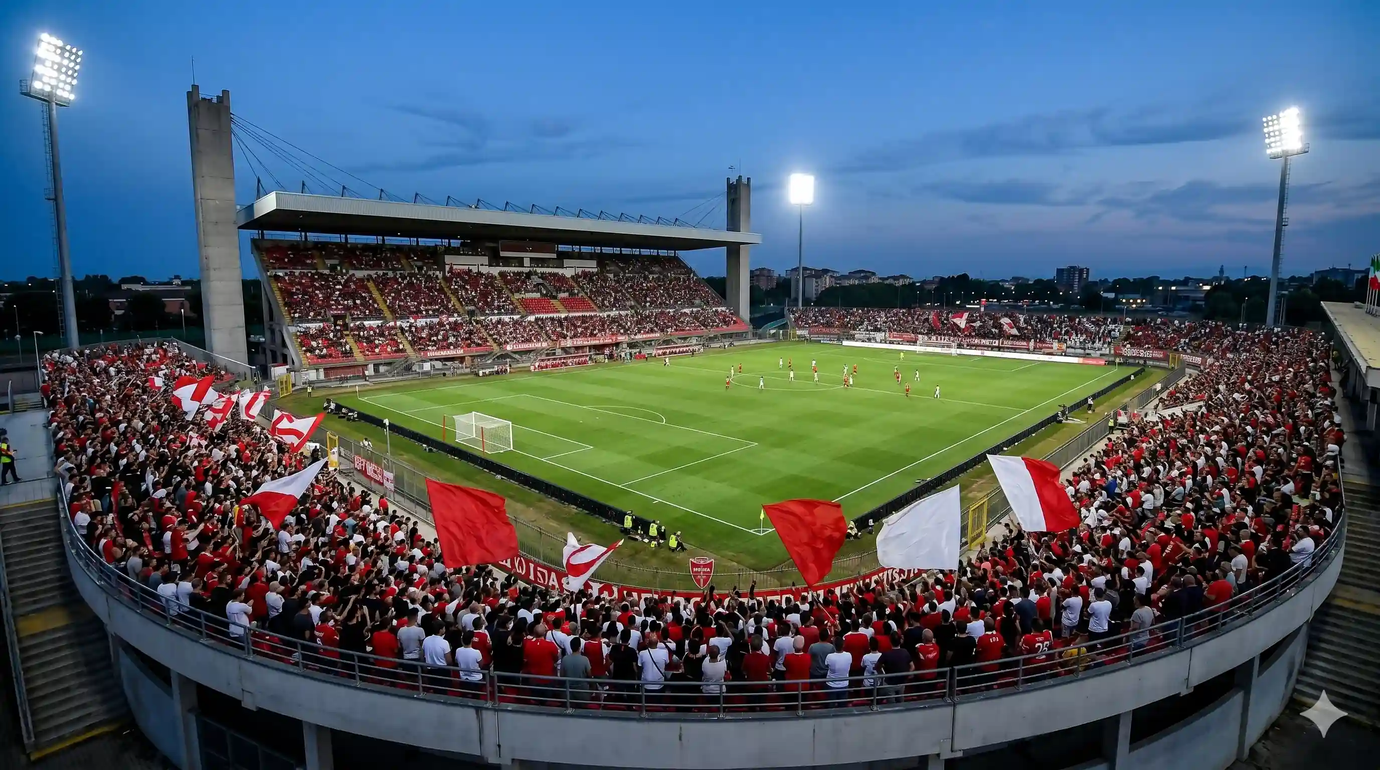 Tifosi Monza bianco e rosso allo stadio U-Power illuminato di notte.