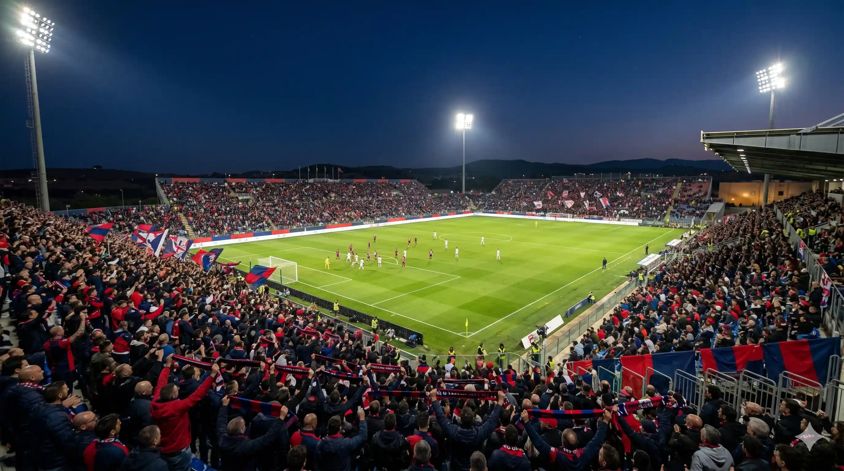 Tifosi Cagliari rosso e blu all'Unipol Domus in Sardegna di notte.